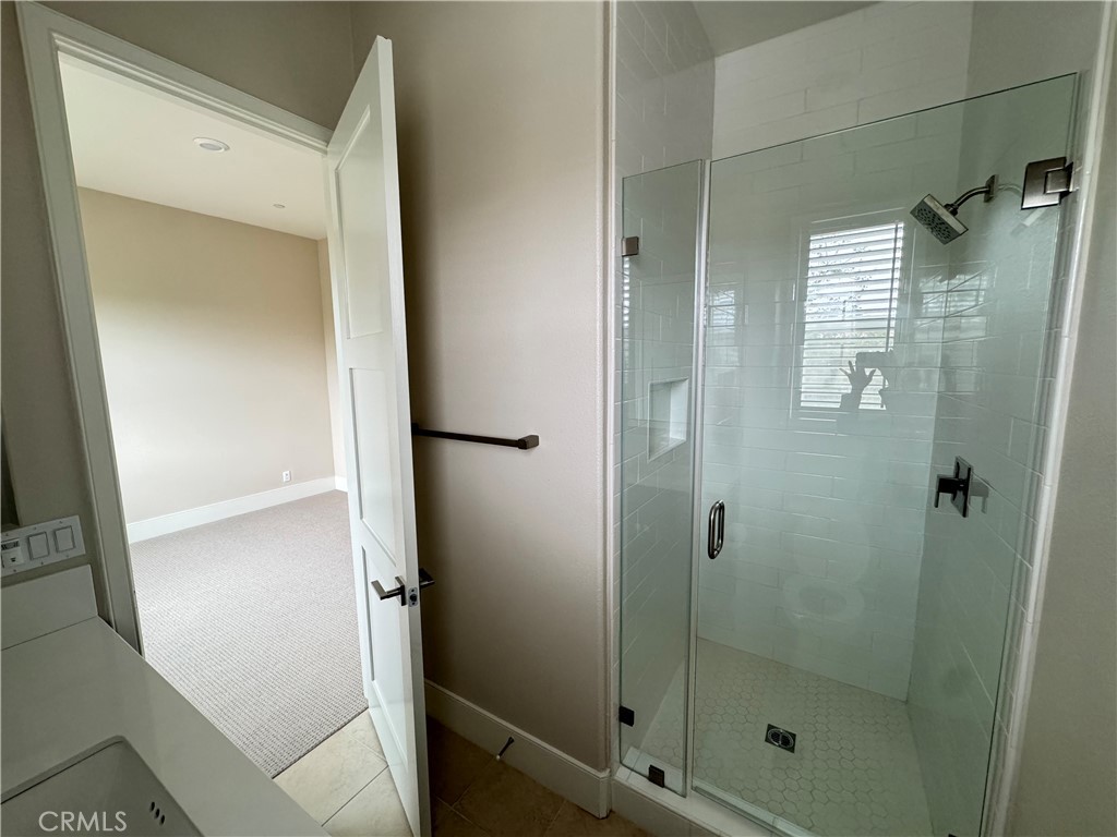 114 Crossover Irvine, CA 92618 - Photo 25 of 41 a bathroom with a glass shower door