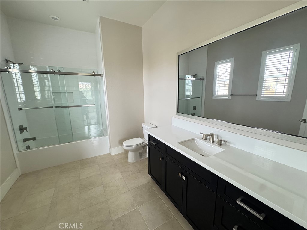 114 Crossover Irvine, CA 92618 - Photo 27 of 41 a spacious bathroom with a double vanity sink a large mirror and a bathtub
