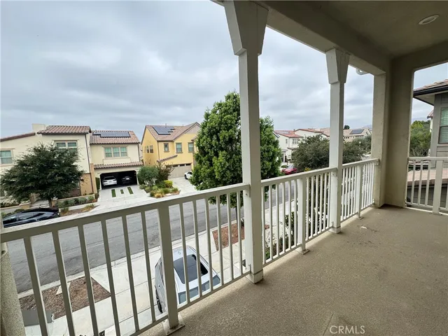 a view of a livingroom with stairs and a window