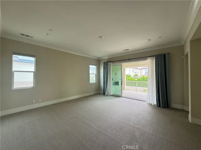 a view of a room with an empty space and balcony
