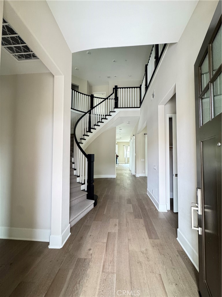 114 Crossover Irvine, CA 92618 - Photo 4 of 41 a view of a hallway view with wooden floor and staircase