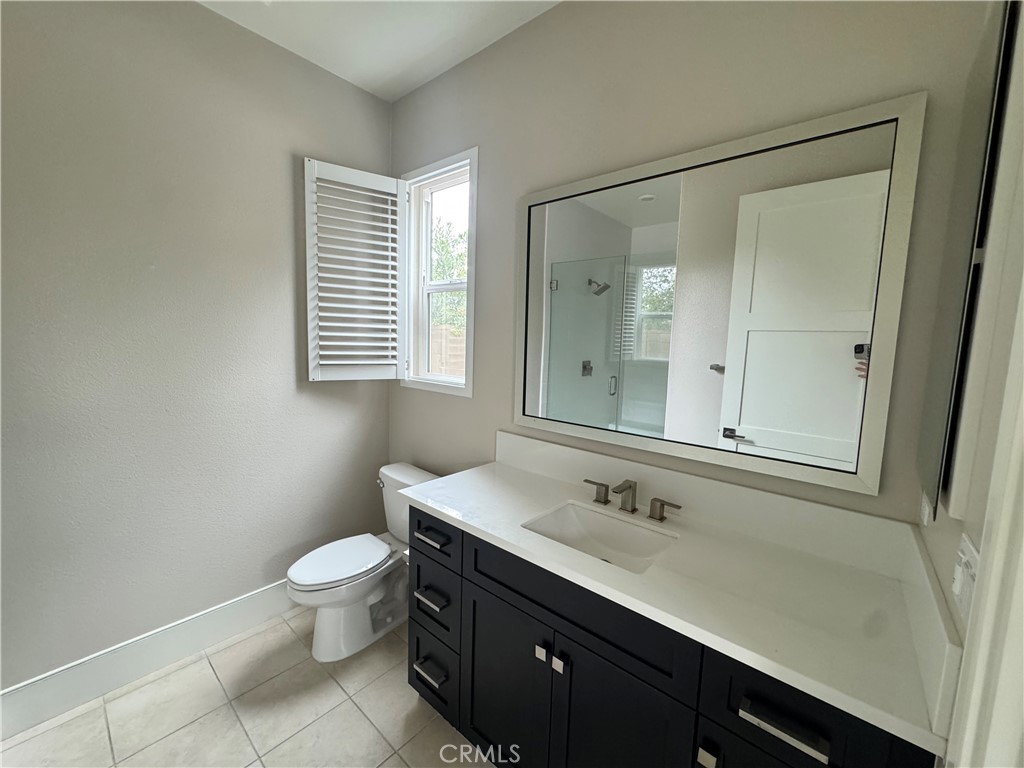 114 Crossover Irvine, CA 92618 - Photo 6 of 41 a bathroom with a sink a toilet a mirror and vanity