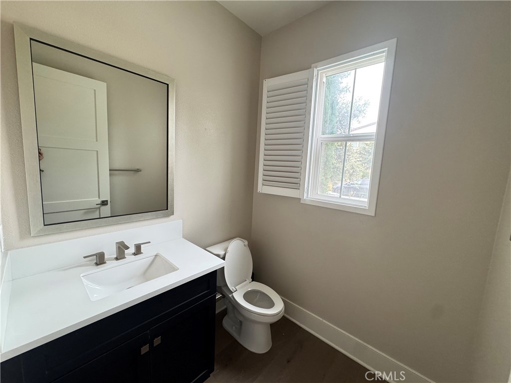 114 Crossover Irvine, CA 92618 - Photo 9 of 41 a bathroom with a toilet a sink a mirror and a window