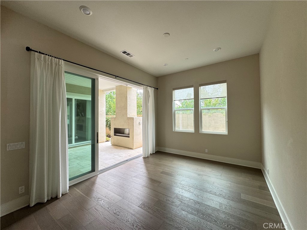 114 Crossover Irvine, CA 92618 - Photo 10 of 41 an empty room with wooden floor and windows