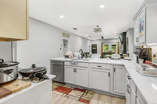 a kitchen with a sink appliances and cabinets