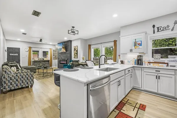 a open kitchen with stainless steel appliances granite countertop a sink and cabinets