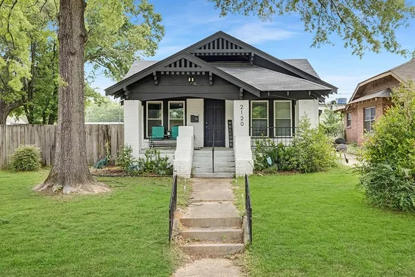 a front view of house with a garden
