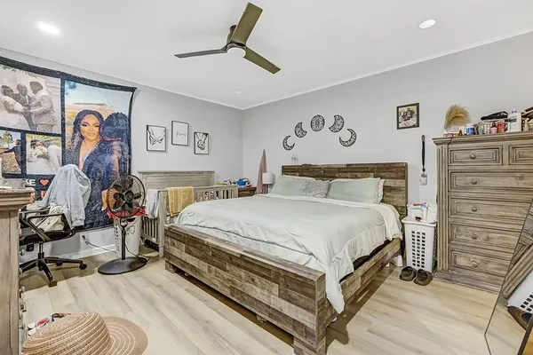 a bedroom with a bed and dresser