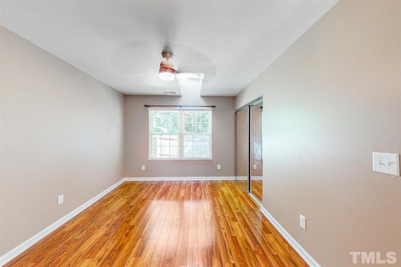5309 Golden Moss Trail Raleigh, NC 27613 - Photo 11 of 25 a view of empty room with wooden floor and fan