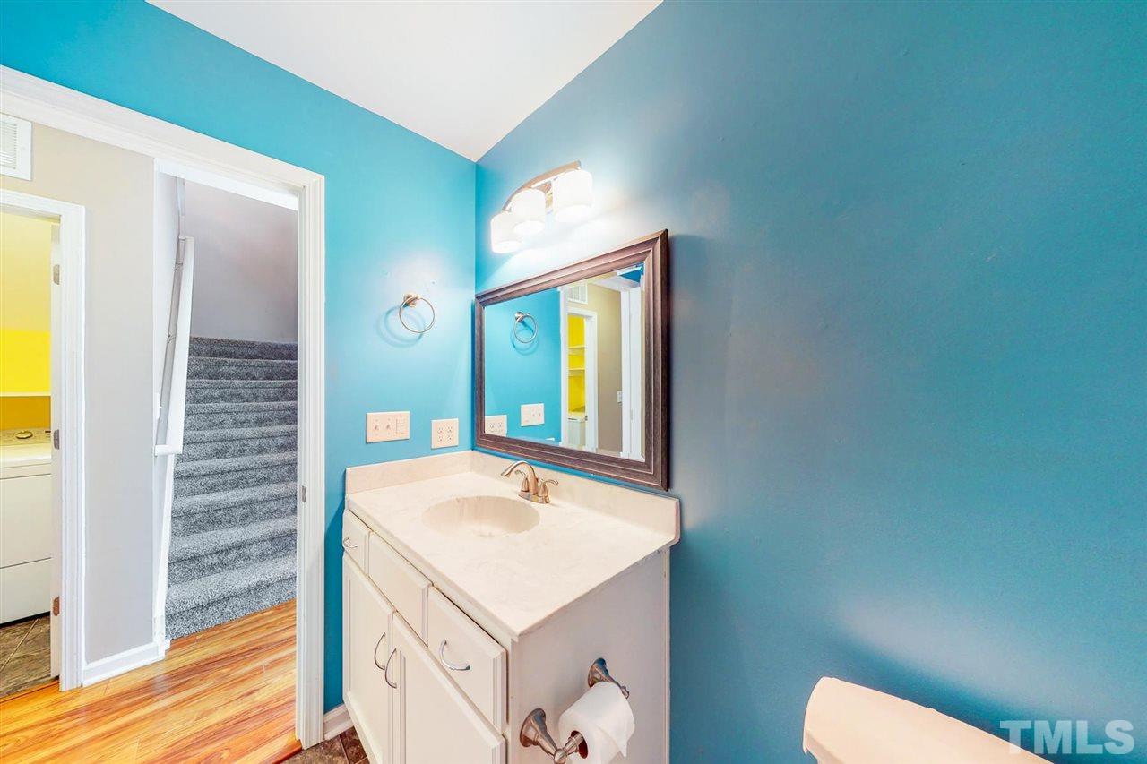 5309 Golden Moss Trail Raleigh, NC 27613 - Photo 14 of 25 a bathroom with a sink and a mirror