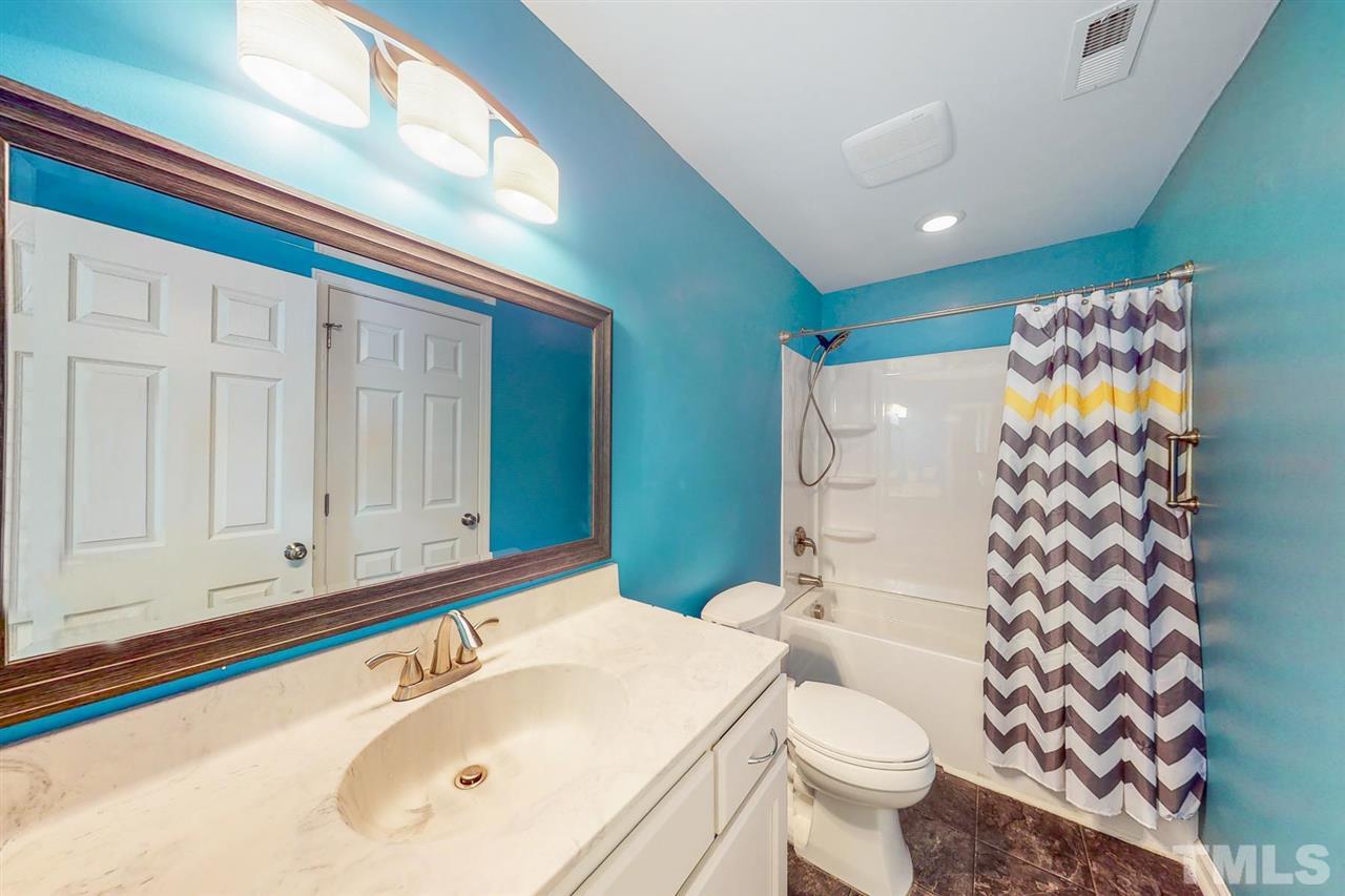 5309 Golden Moss Trail Raleigh, NC 27613 - Photo 15 of 25 a bathroom with a sink toilet and shower