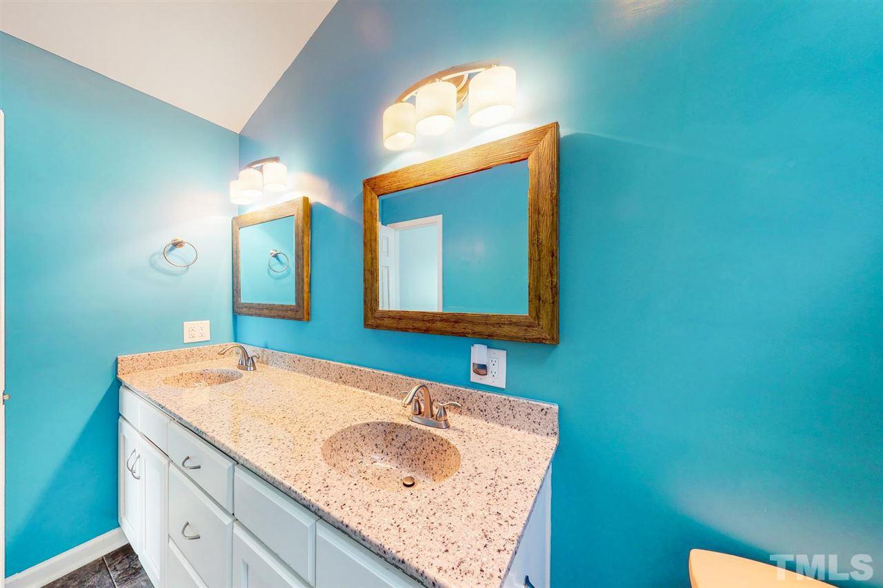 5309 Golden Moss Trail Raleigh, NC 27613 - Photo 18 of 25 a bathroom with a sink and a mirror