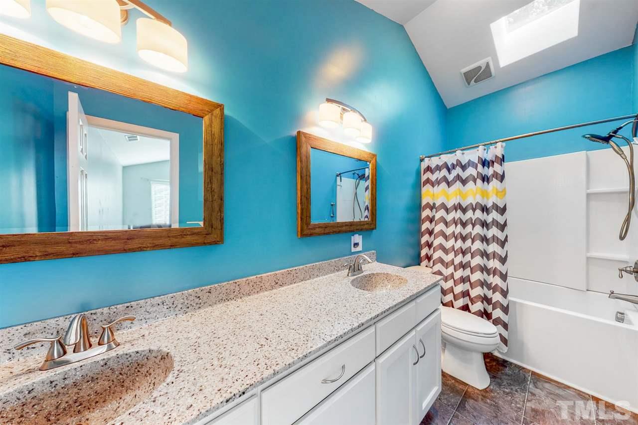 5309 Golden Moss Trail Raleigh, NC 27613 - Photo 19 of 25 a bathroom with a granite countertop sink and a mirror