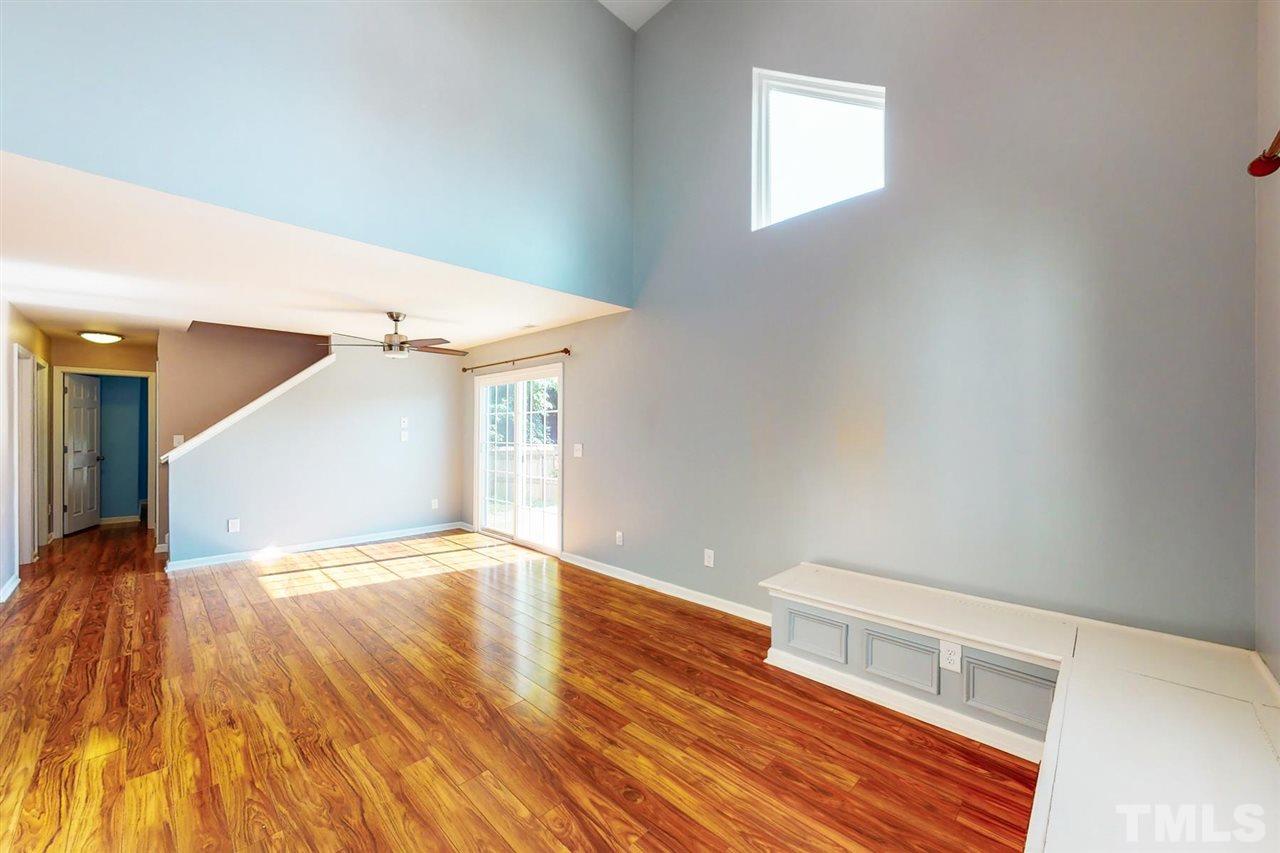 5309 Golden Moss Trail Raleigh, NC 27613 - Photo 3 of 25 a view of an empty room with wooden floor and a window