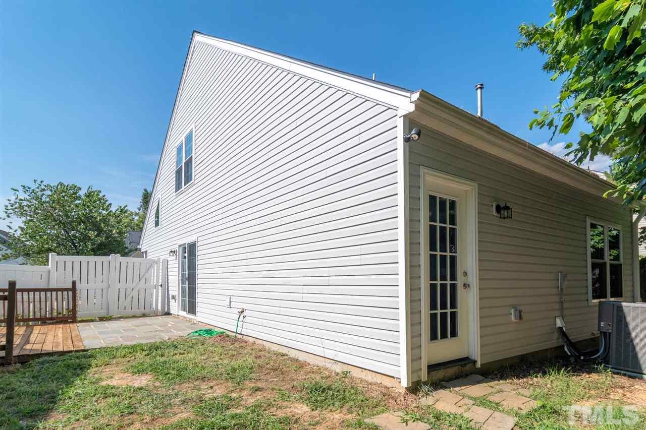 5309 Golden Moss Trail Raleigh, NC 27613 - Photo 25 of 25 a view of a white house with a small yard and wooden fence