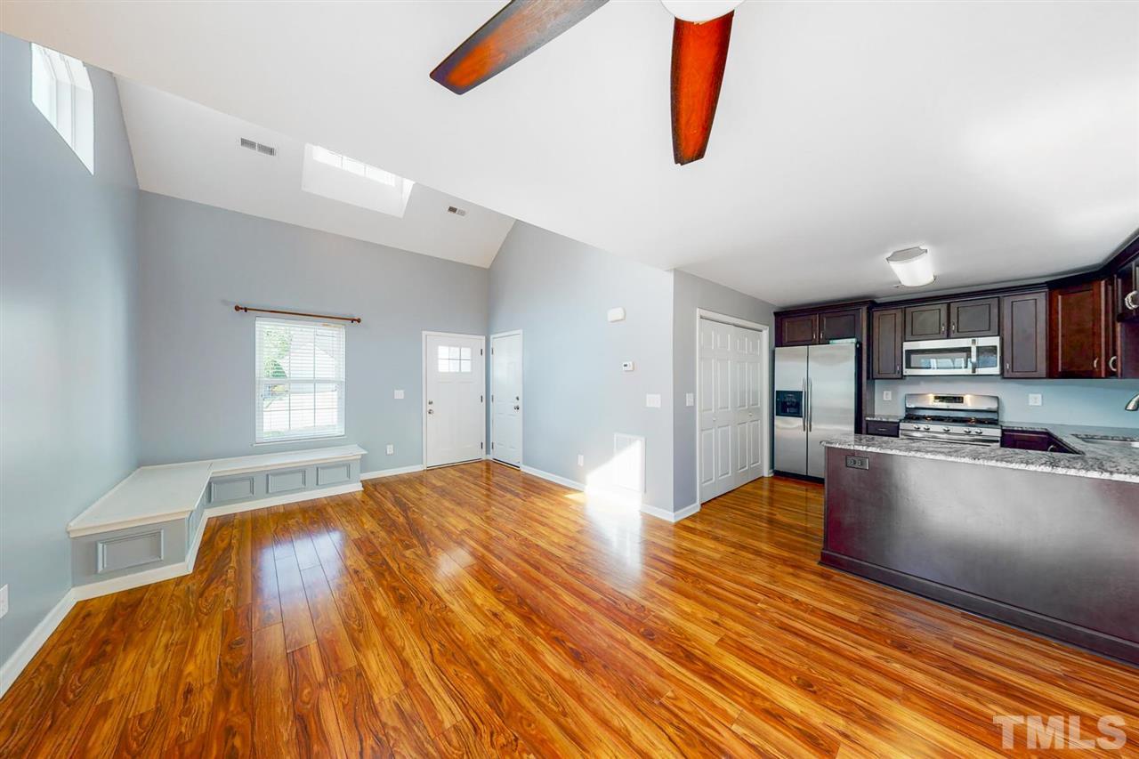 5309 Golden Moss Trail Raleigh, NC 27613 - Photo 8 of 25 a bedroom with kitchen island a bed wooden floor and window