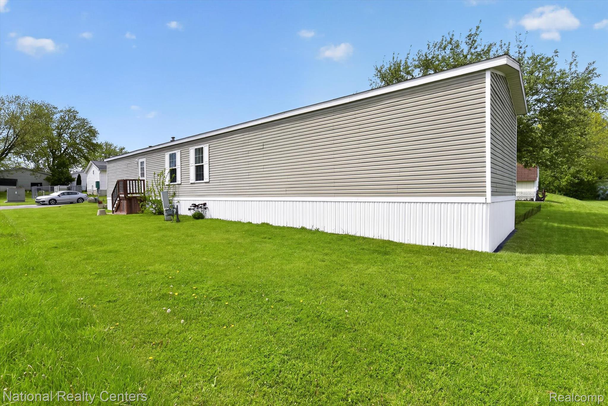 2735 South Wagner Road, Unit 103 Ann Arbor, MI 48103 - Photo 18 of 20 View of home's exterior with a yard
