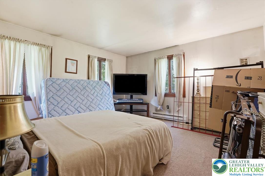 143 Logger Road Canadensis, PA 18325 - Photo 12 of 32 Well-lit sleeping quarters with comfortable carpeting, ready for personalization.