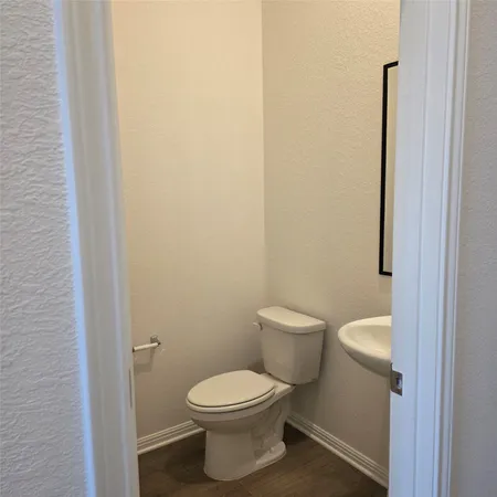 a white toilet sitting next to a shower