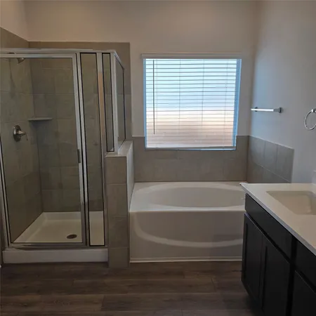 a bathroom with a bathtub and a shower