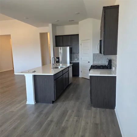 a kitchen with stainless steel appliances granite countertop a sink counter space and cabinets