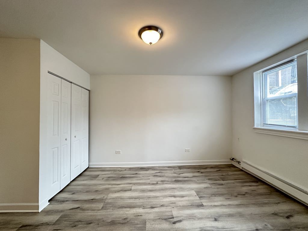 5710 North Winthrop Avenue, Unit 113 Chicago, IL 60660 - Photo 13 of 20 wooden floor in an empty room