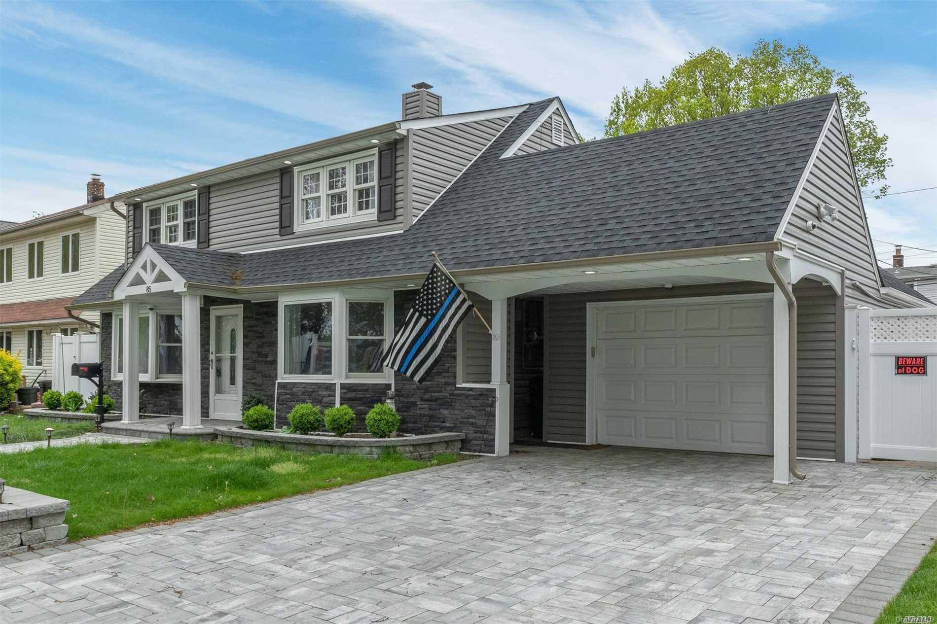 85 Azalea Road Levittown, NY 11756 - Photo 1 of 1 a view of a house with brick walls and a yard with plants