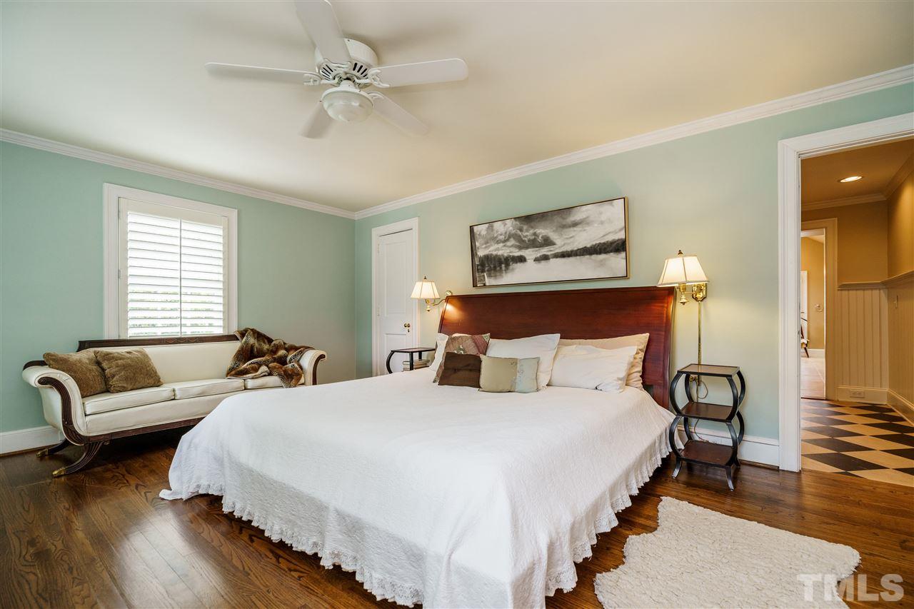 1501 St Marys Street Raleigh, NC 27608 - Photo 14 of 30 Hardwood floors, plantation shutters, and soothing fan for a good night's sleep.