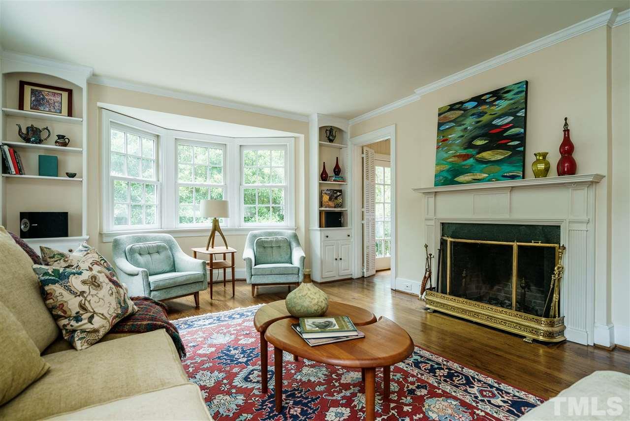 1501 St Marys Street Raleigh, NC 27608 - Photo 3 of 30 Wood-burning fireplace makes the family room cozy. Potential TV nook is flanked by built-ins.