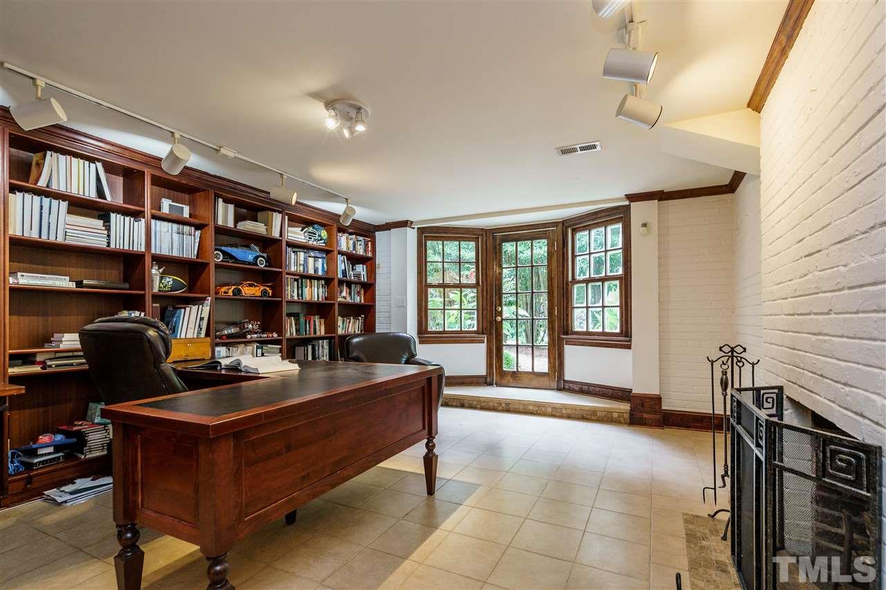 1501 St Marys Street Raleigh, NC 27608 - Photo 24 of 30 Grand office space with fireplace, built-ins, and access to the side yard. No need for that office? Picture the potential as kid play space (basement bonus) or studio-style living for older children and adults alike.