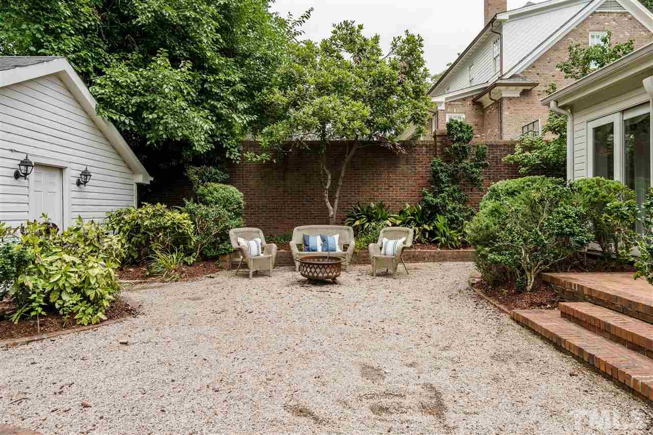 1501 St Marys Street Raleigh, NC 27608 - Photo 27 of 30 Brick patio leads to the backyard retreat. Fully fenced in on this .35 acre lot. Access the detached garage and private driveway off Williamson.