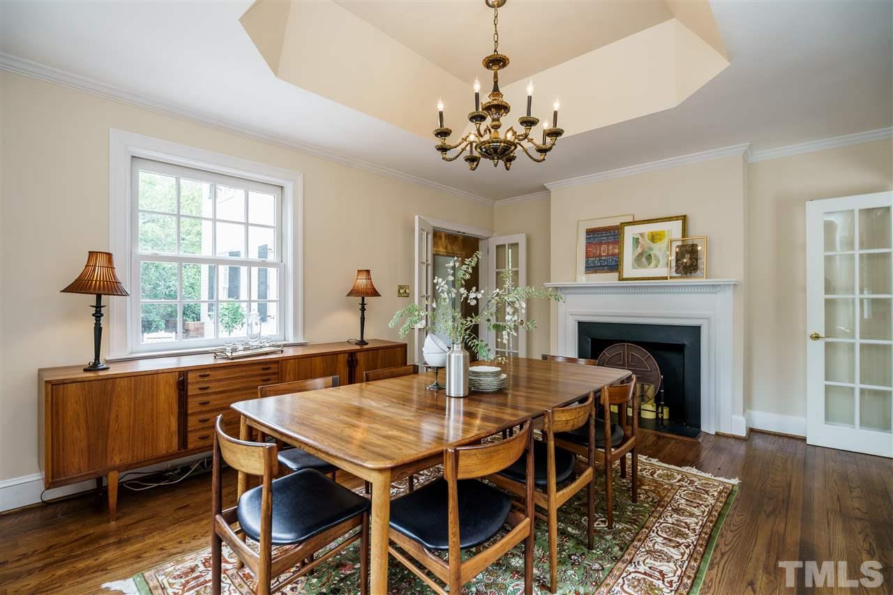 1501 St Marys Street Raleigh, NC 27608 - Photo 9 of 30 Formal dining with fireplace...imagine the memorable holiday dinners here. French doors enclose the space for festive affairs.
