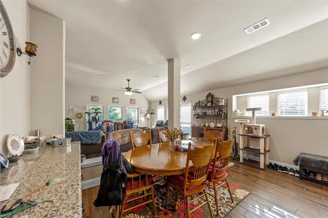 a view of a dining room with furniture and wooden floor