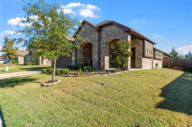 a front view of a house with yard and outdoor seating