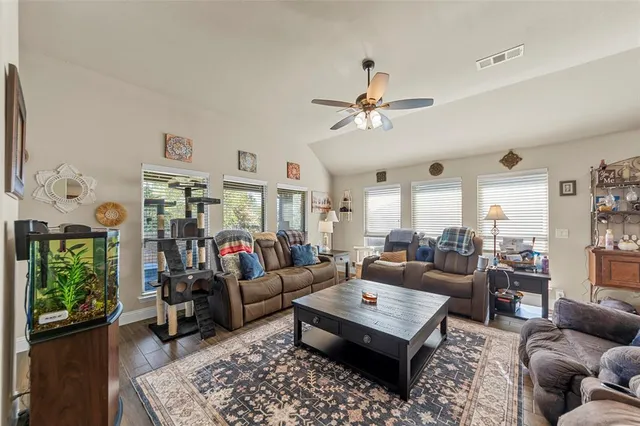 a living room with furniture kitchen view and a window