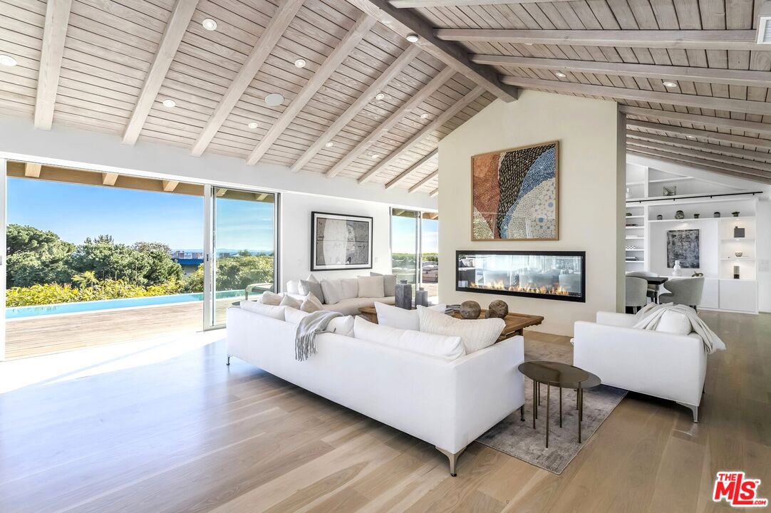 1822 Westridge Road Los Angeles, CA 90049 - Photo 1 of 1 a living room with furniture and a large window