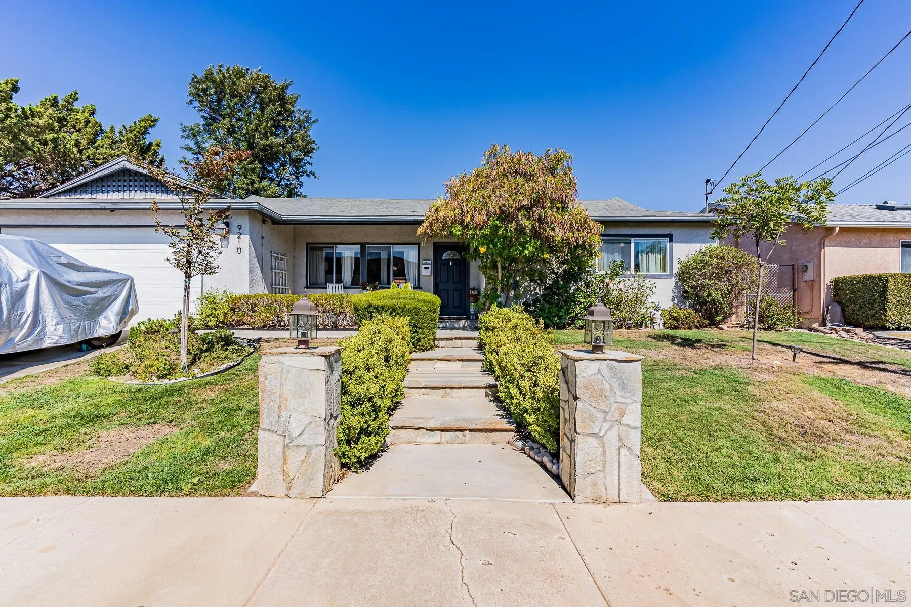 9210 Dalehurst Road Santee, CA 92071 - Photo 3 of 25 a front view of a house with a yard and fountain