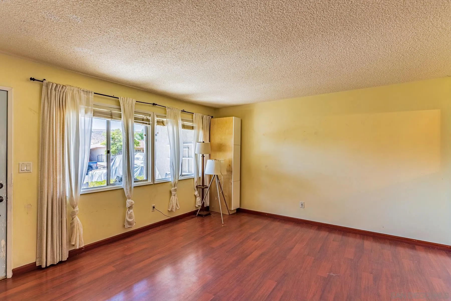 9210 Dalehurst Road Santee, CA 92071 - Photo 4 of 25 an empty room with wooden floor and windows