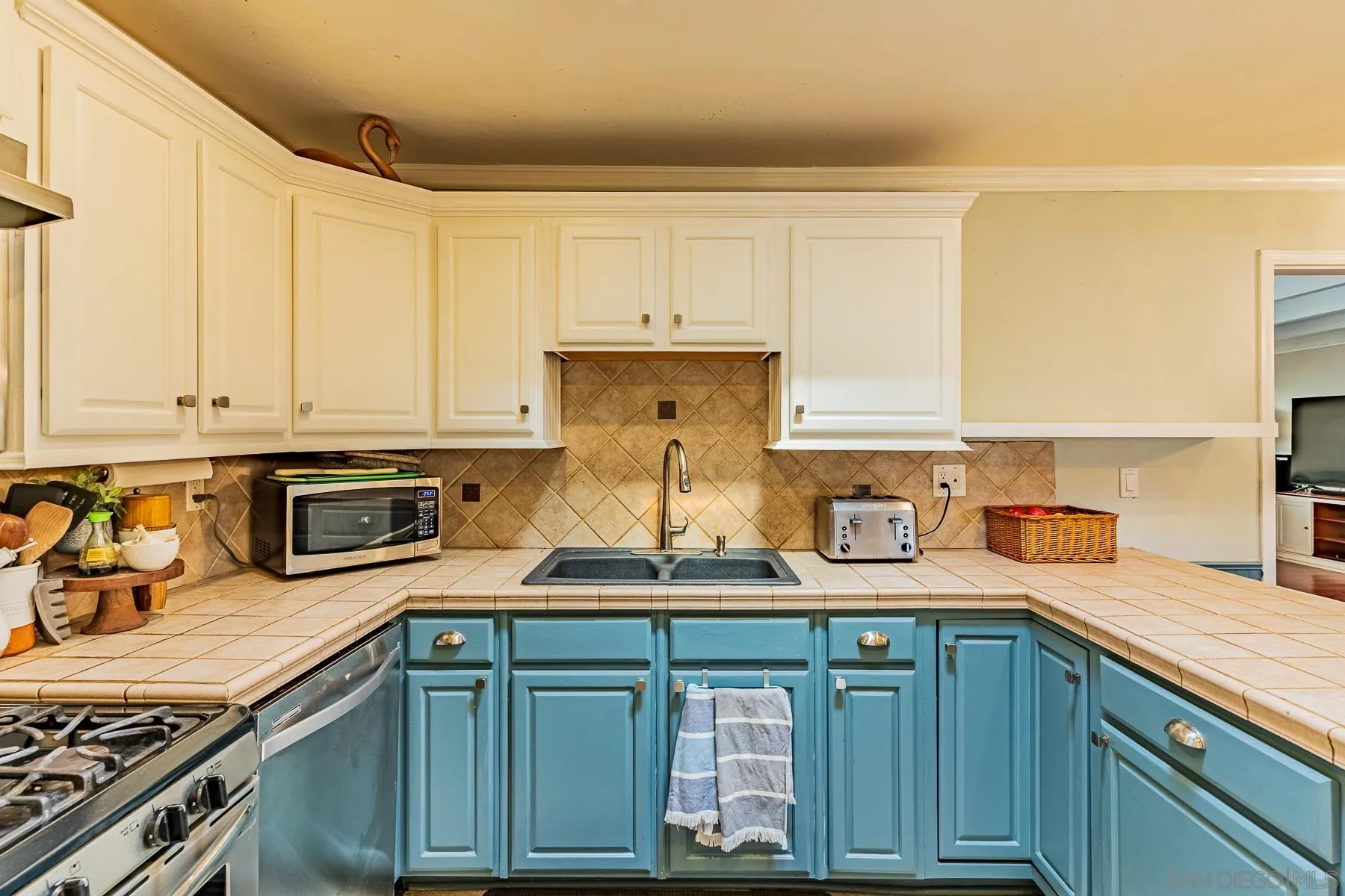 9210 Dalehurst Road Santee, CA 92071 - Photo 7 of 25 a kitchen with granite countertop a sink a stove and cabinets