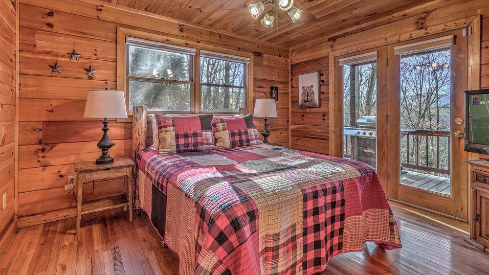 348 The Forest Has Eyes Blue Ridge, GA 30513 - Photo 30 of 49 a large bed sitting in a bedroom next to a window