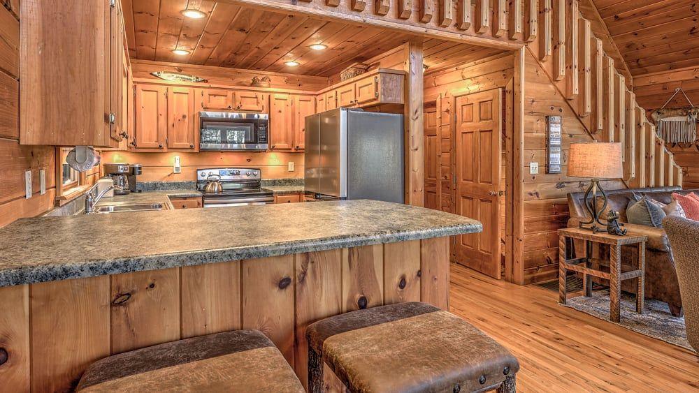 348 The Forest Has Eyes Blue Ridge, GA 30513 - Photo 3 of 49 a kitchen with stainless steel appliances granite countertop a sink and a refrigerator