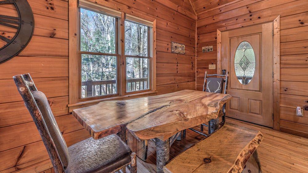 348 The Forest Has Eyes Blue Ridge, GA 30513 - Photo 32 of 49 a view of a dining room with furniture window and wooden floor