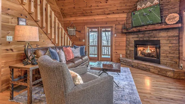 a living room with furniture and a fireplace