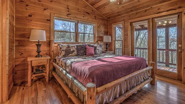 a bed sitting in a bedroom next to a window