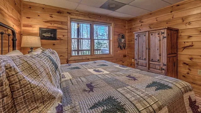 a bed sitting in a bedroom next to a window