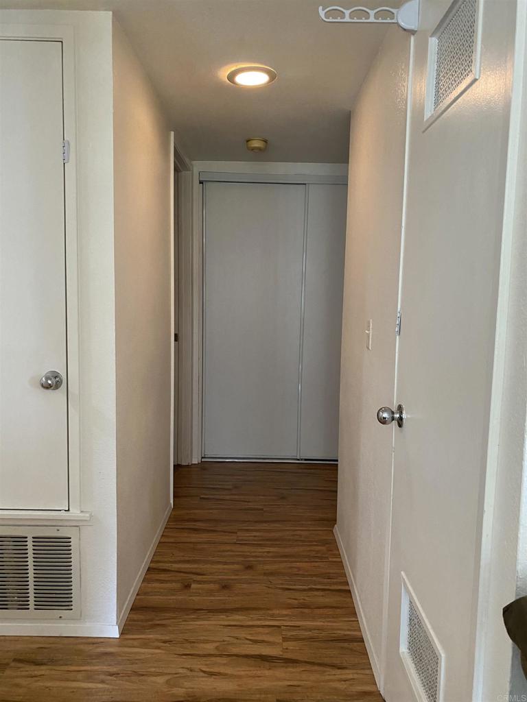 230 Diamond Way, Unit 148 Vista, CA 92083 - Photo 11 of 18 a view of a hallway with wooden floor