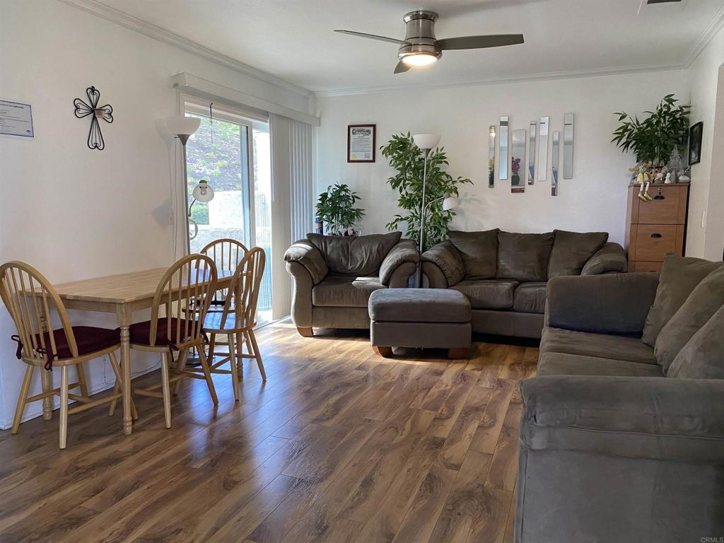 230 Diamond Way, Unit 148 Vista, CA 92083 - Photo 2 of 18 a living room with furniture wooden floor and dining table