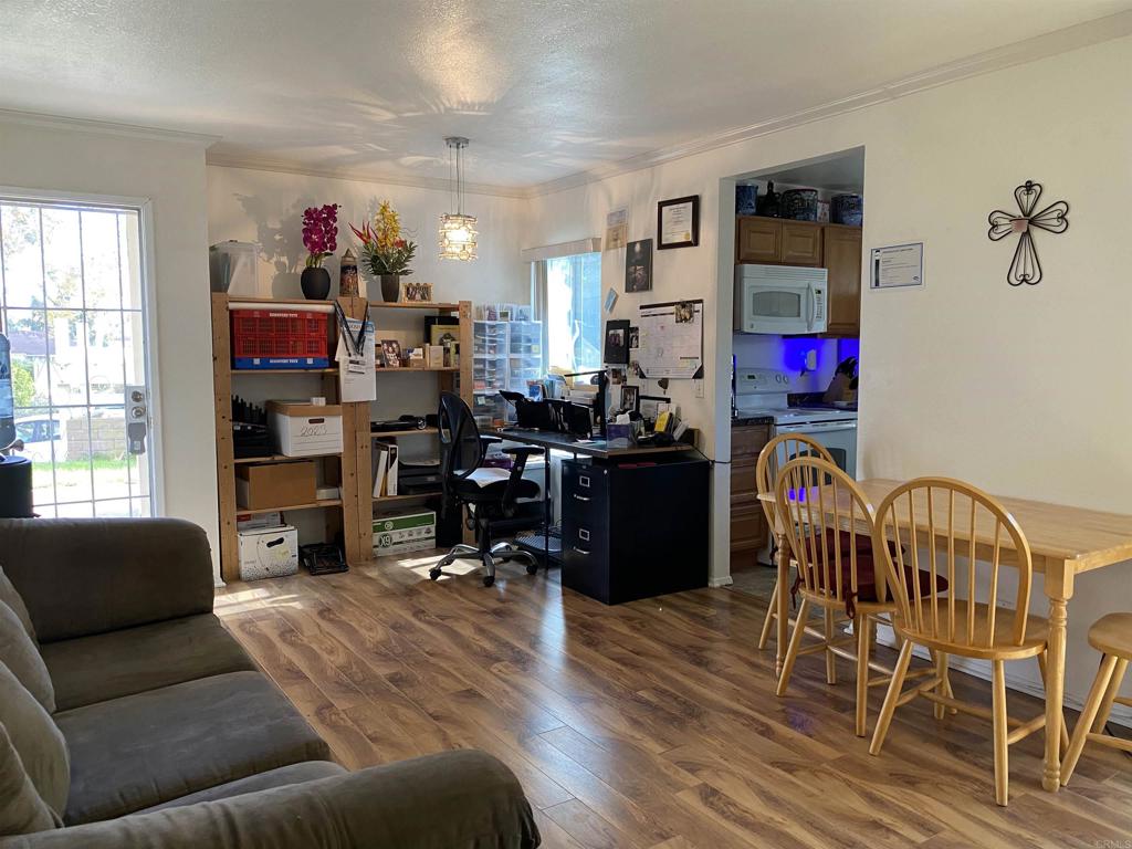 230 Diamond Way, Unit 148 Vista, CA 92083 - Photo 3 of 18 a living room with furniture and a flat screen tv