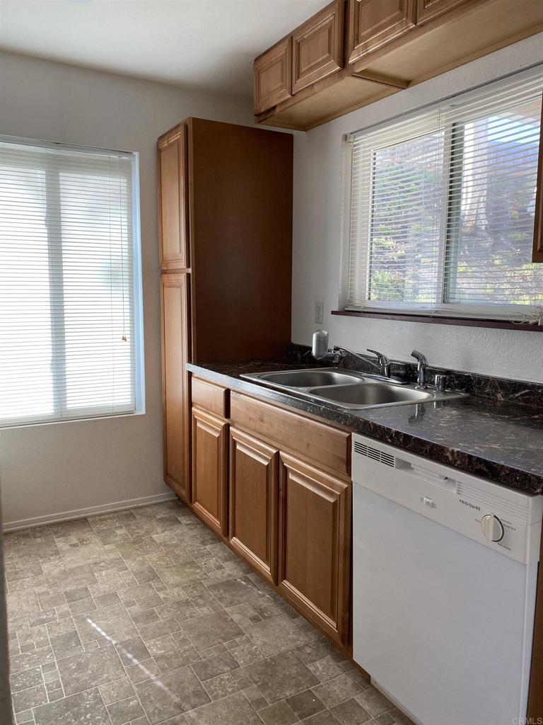 230 Diamond Way, Unit 148 Vista, CA 92083 - Photo 4 of 18 a kitchen with granite countertop a sink and a stove