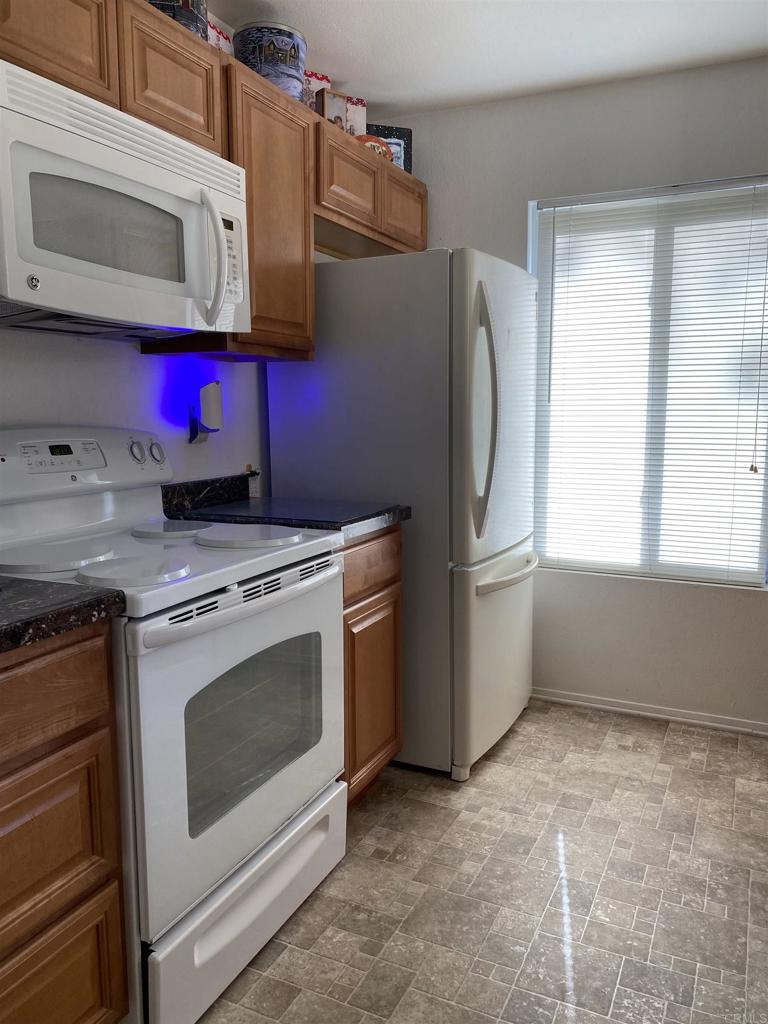 230 Diamond Way, Unit 148 Vista, CA 92083 - Photo 5 of 18 a utility room with stainless steel appliances cabinets and a window